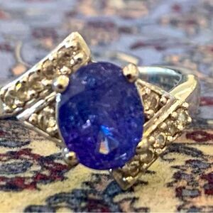 Real mined from the earth Tanzanite flanked by natural white zircon. Size 7